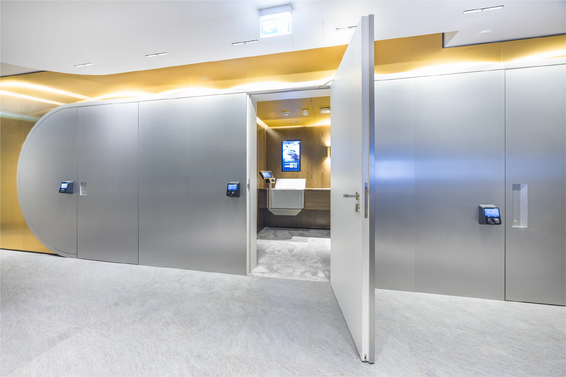 Open vault room door with access terminals and a view into a Trisor private cabin with a digital display