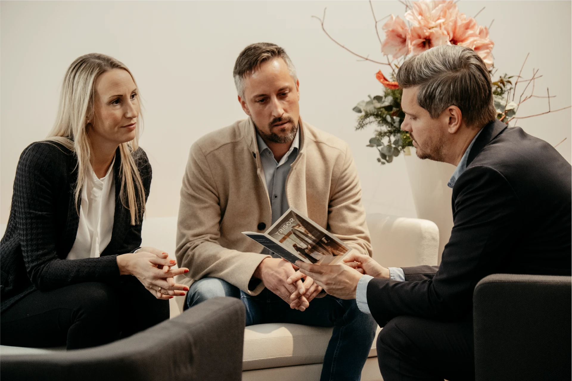 Trisor advisor explaining the Trisor brochure to a couple during a consultation