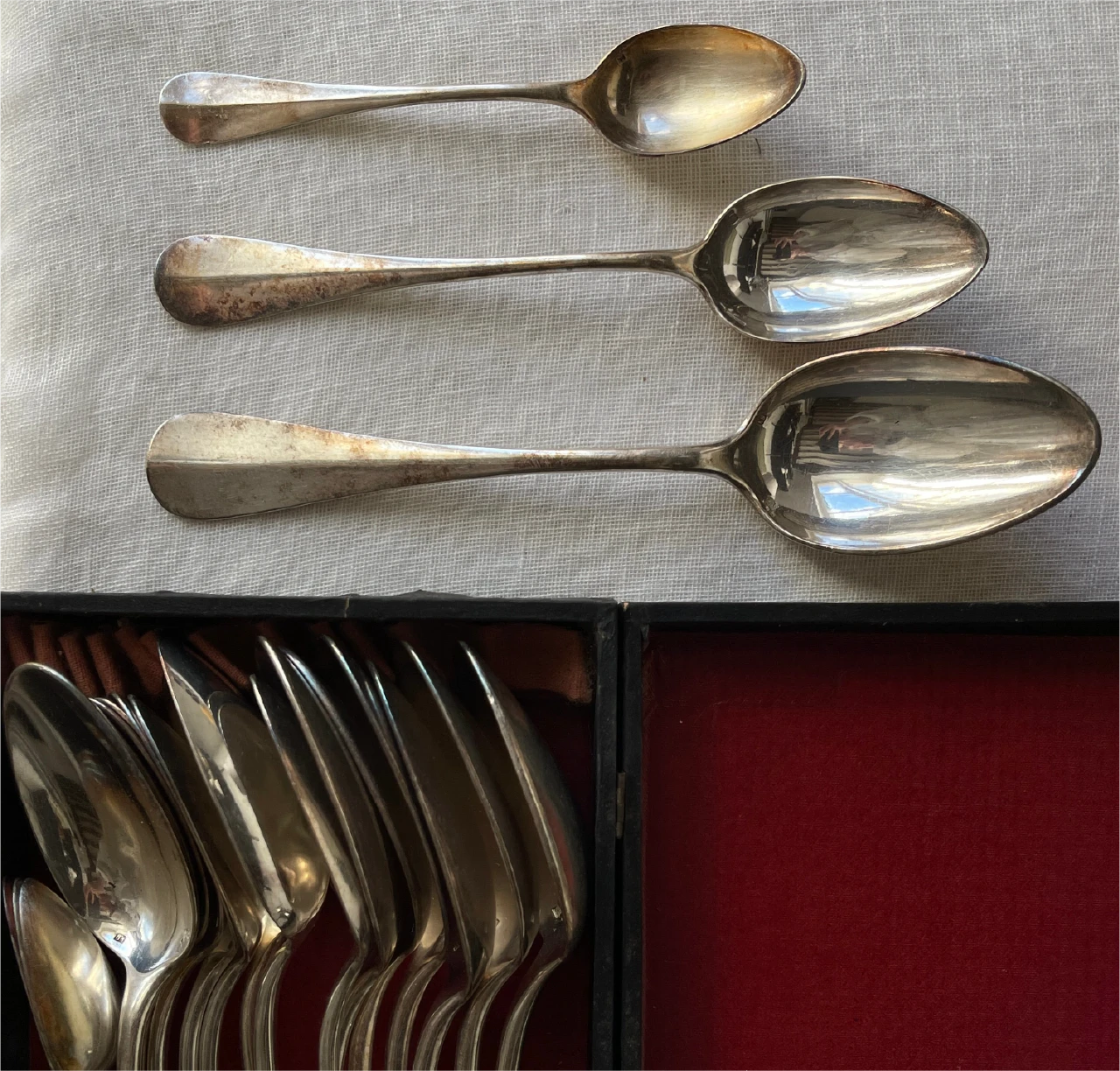 Silver cutlery on cloth and in a case